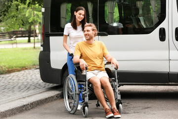 Young woman with her handicapped husband near car outdoors