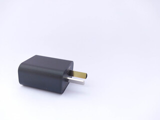 Black cell phone charger on white background
