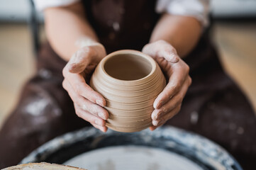 Master class on modeling of clay on a potter wheel In the pottery workshop - 367855543