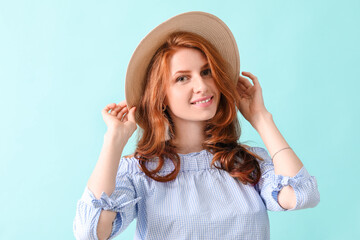 Fototapeta premium Beautiful young redhead woman on color background
