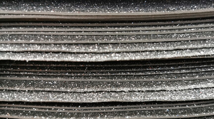 background of black shinny paper view from the side