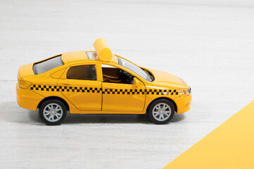 Fototapeta na wymiar Yellow taxi car on a yellow background. Taxi