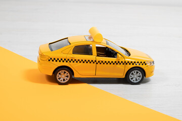 Toy yellow taxi car. Children's toy taxi.