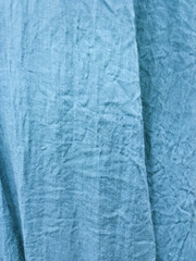crumpled blue fabric background with selective focus