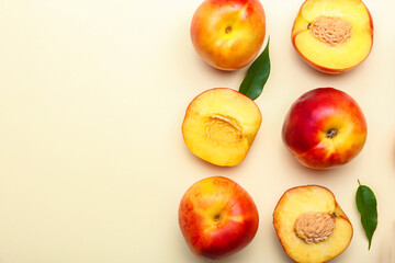 Fototapeta na wymiar Sweet ripe nectarines on color background