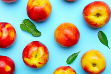 Sweet ripe nectarines on color background