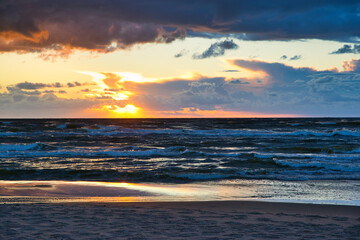 Fototapeta premium Sunset view over the sea. Beautiful sunset over the sea. View of the beach, sea and sunset.