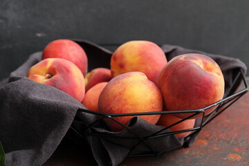 Fototapeta na wymiar Basket with ripe peaches on table