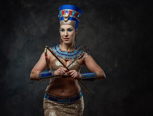Woman in egyptian costume with distinctive attributes of power
