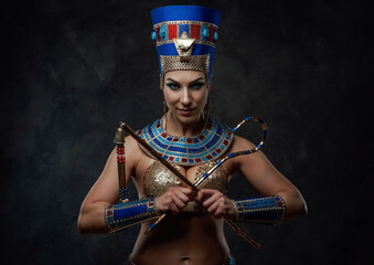 Beautiful woman in egyptian blue and gold costume with some red details