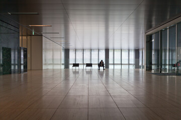 Silhouetted businesspeople in corporate office lobby