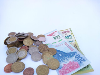 Banknotes and coins on white background