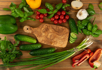 Sliced Cucumber with Green Vegetables on Rustic Cutting Board