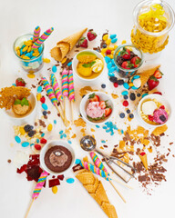 Obraz na płótnie Canvas Strawberry, butter scotch, vanilla and mango ice cream with candy and lollipops.