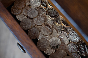 Bullion gold coins in a drawer. Austrian Philharmoniker pure gold coins hidden in old wooden drawer. Conservative investor's portfolio.