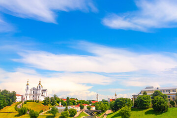 Vitebsk,Belarus - 21 July 2020 : Holy Assumption Cathedral of the Assumption on the hill and the Holy Spirit convent and Scenic view of beautiful blue sky with fluffy white clouds. Vitebsk, Belarus