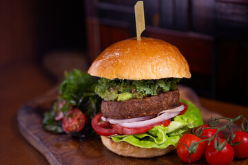 A beyond delicious plant based non meat burger with lettuce, onion, tomato and vegan buns.