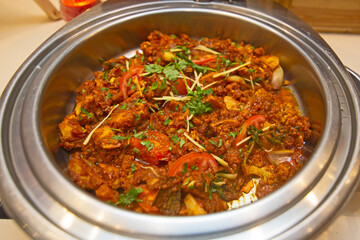 Aloo Gobi mutter Indian curry dish with potatoes and cauliflower and green peas.