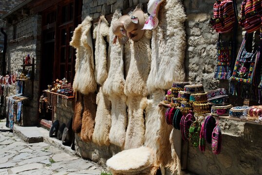 Lahic. A display of traditional Azeri souvenir hats, bags and sheepskin furs on the Main Street of Lahic, a highland village in Azerbaijan.