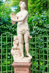 Statue "Youth" in old city park "Summer garden" in St. Petersburg, Russia