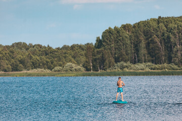 Boys on rafts swim on water