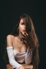 Naklejka premium Close-up portrait of a beautiful caucasian girl with long brown hair. Haircare, Skincare concept