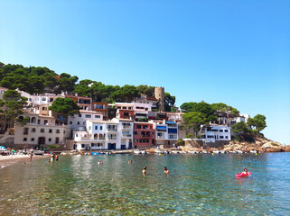 Fototapeta na wymiar 26.07.2020: Sa Tuna, Begur, Costa Brava, Spain. Colorful houses in sea bay with beach in coastal mediterranean village.