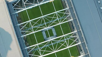 Aerial view of soccer arena. Game played without spectators due to Coronavirus Covid19 virus outbreak. Match between soccer teams played in empty stadium. Aerial top down view. - Powered by Adobe