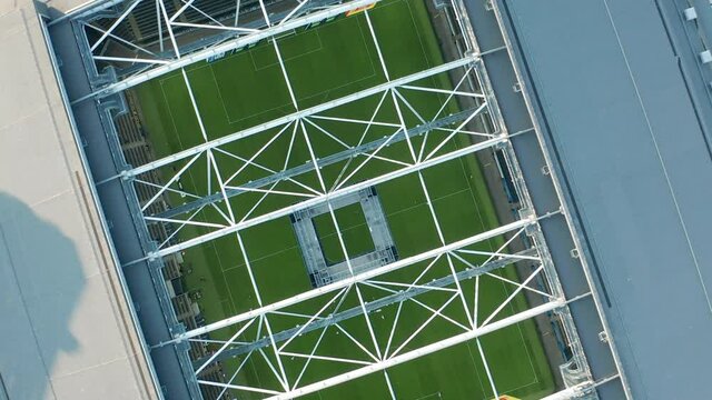 Aerial view of soccer arena. Game played without spectators due to Coronavirus Covid19 virus outbreak. Match between soccer teams played in empty stadium. Aerial top down view.