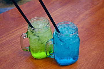 green and blue cocktail drinks with crushed ice.