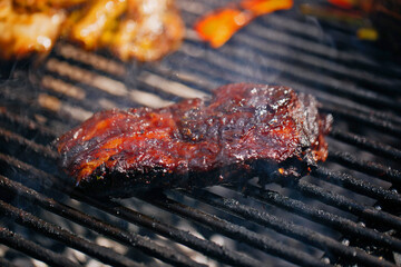 Beef steaks, lamb on the grill with flames and smoke. bbq.
