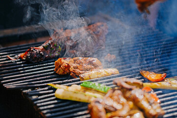Beef steaks and lamb on the grill with flames and smoke. bbq.