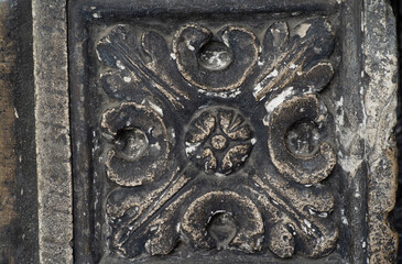 the decorative ornament on the stone of the old building