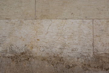 Gray colored lime stone wall texture. Brushed blocks with flat cuts.