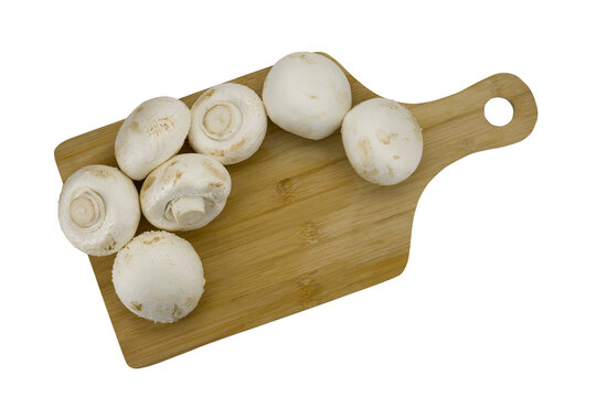 
mushrooms champignons on wooden board