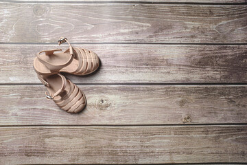 Rubber Brown baby girl sandals shoes on a wooden floor