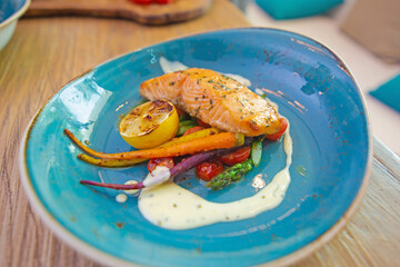 Salmon steak with grilled vegetables and sauce
