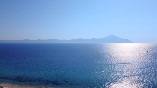 Beautiful Aegean sea in summer morning with view to Athos mount. Aerial view 