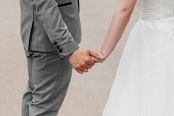 
the groom holds the bride's hand close-up