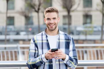 Making communication easier. Happy guy use smartphone outdoors. Mobile communication. Conversation and chat. Using communication technology. Modern life. Texting, email and instant messaging