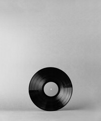 Obraz premium Black vinyl music record isolated on abstract gray background with shadows and empty space