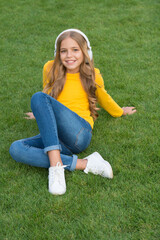 Fototapeta premium Cute smiling girl modern headphones enjoy music relaxing outdoors, digital sound concept