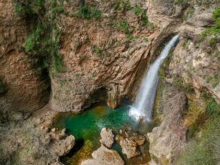 Aerial view of waterfall splashing over mountain
