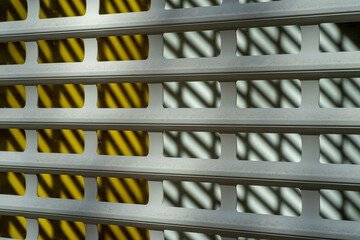 Modern rhythmic pattern sliding metal blinds for protection.