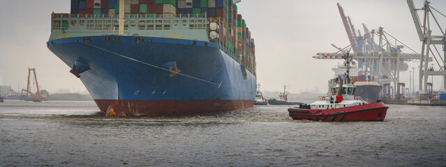 Cargo ship in the harbor of Hamburg at rainy weather