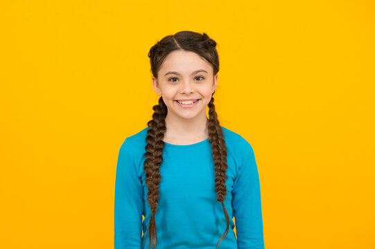 happy childrens day. beautiful braided long hair. stylish braids and pigtails. cute teenage girl. professional hairdo. kid fashion and beauty. small girl after hairdresser salon. childhood happiness