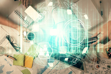Double exposure of man and woman working together and social network theme hologram drawing. Computer background. connecting concept. Top View.