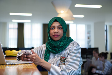 african muslim business woman using mobile phone