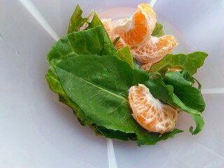 tangerine and vegetables in cup