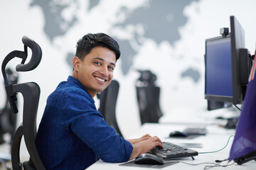 casual indian business man working on desktop computer